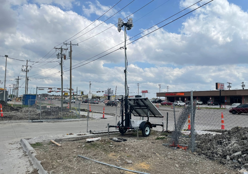 Solar Surveillance Trailer by Chain Link Fence - Header